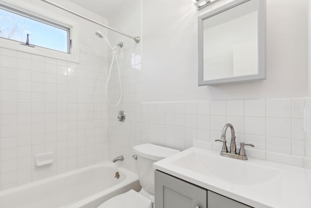 bathroom with backsplash, tile walls, vanity, toilet, and bathing tub / shower combination