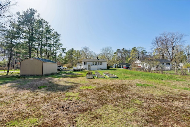 view of yard featuring fence and an outdoor structure