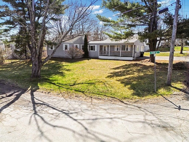 view of front of property with a porch and a front lawn