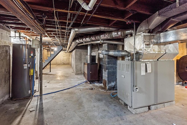 unfinished basement featuring heating fuel, water heater, and stairway