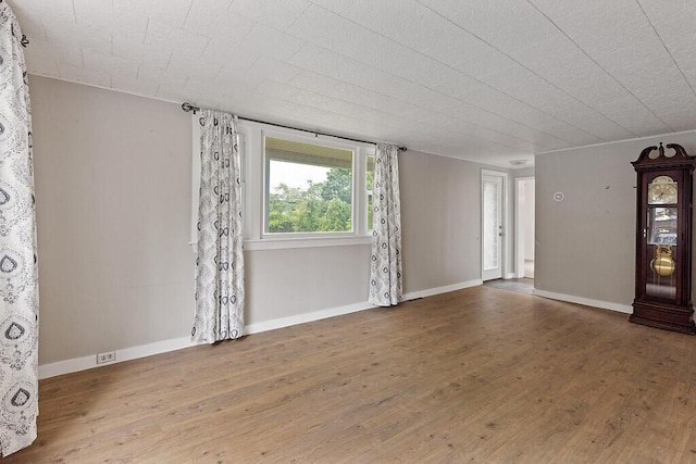 10 Field St, Bangor, ME 04401 - unfurnished room with wood finished floors and baseboards