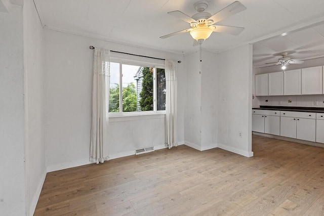 10 Field St, Bangor, ME 04401 - unfurnished room featuring light wood-style floors, a ceiling fan, and baseboards