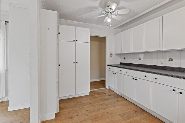 10 Field St, Bangor, ME 04401 - kitchen with dark countertops, ceiling fan, tasteful backsplash, and white cabinetry