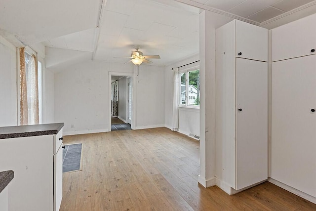 10 Field St, Bangor, ME 04401 - unfurnished living room with light wood-style floors, a ceiling fan, vaulted ceiling, and baseboards