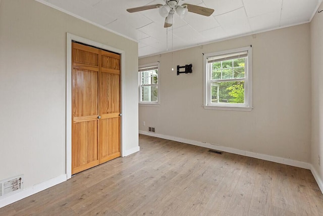 10 Field St, Bangor, ME 04401 - unfurnished bedroom featuring light wood-type flooring, ornamental molding, baseboards, and a closet