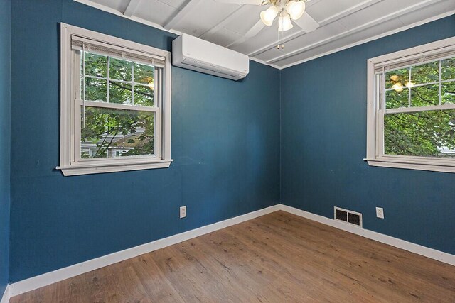 10 Field St, Bangor, ME 04401 - spare room with a wall mounted AC, wood finished floors, ceiling fan, and baseboards