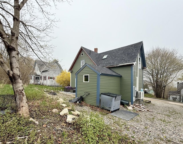 12 Prince Ave, Eastport, ME 04631 - view of side of property with roof with shingles and a chimney