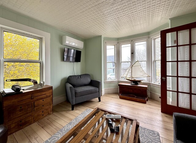 12 Prince Ave, Eastport, ME 04631 - living area with a wall unit AC, hardwood / wood-style floors, and baseboards
