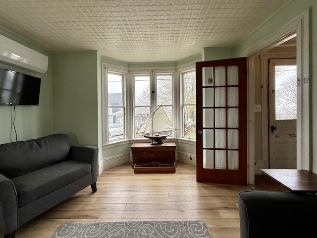 12 Prince Ave, Eastport, ME 04631 - sitting room with plenty of natural light, light wood finished floors, and an AC wall unit