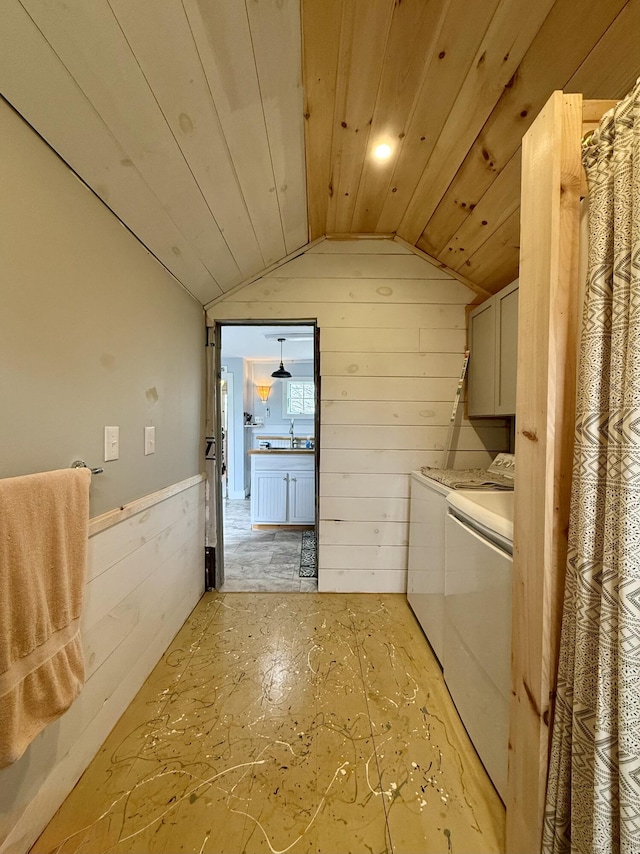 12 Prince Ave, Eastport, ME 04631 - laundry area featuring separate washer and dryer, cabinet space, and wooden walls