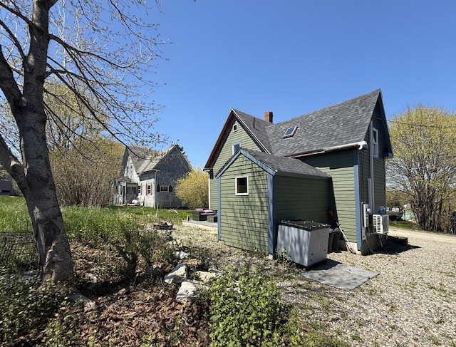12 Prince Ave, Eastport, ME 04631 - view of side of home with a shingled roof and a chimney