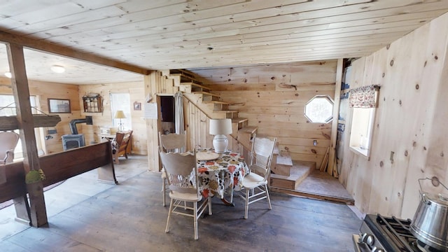 305 Main St N, Searsmont, ME 04973 - dining area with wooden walls, a wood stove, wooden ceiling, and hardwood / wood-style flooring