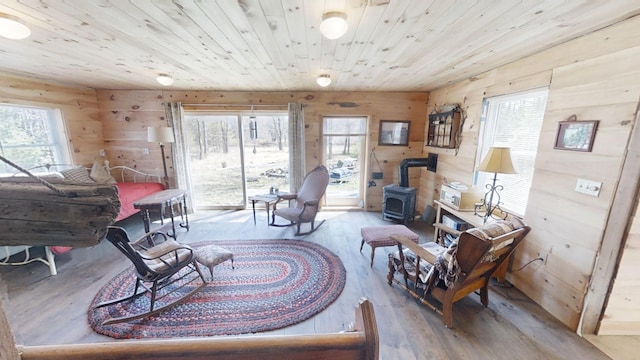 305 Main St N, Searsmont, ME 04973 - living area with a wood stove, wood finished floors, wooden walls, and wooden ceiling
