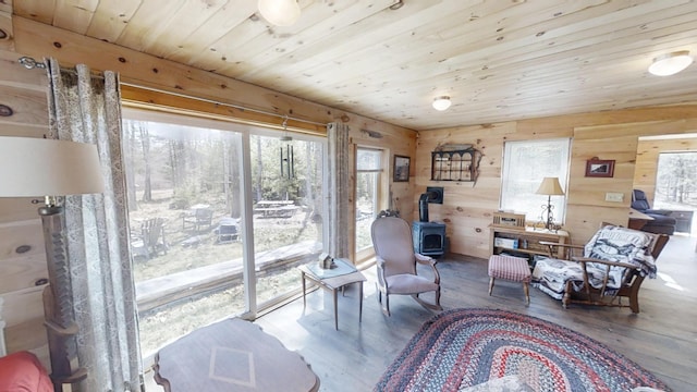 305 Main St N, Searsmont, ME 04973 - sitting room featuring a wood stove, wood finished floors, and a healthy amount of sunlight