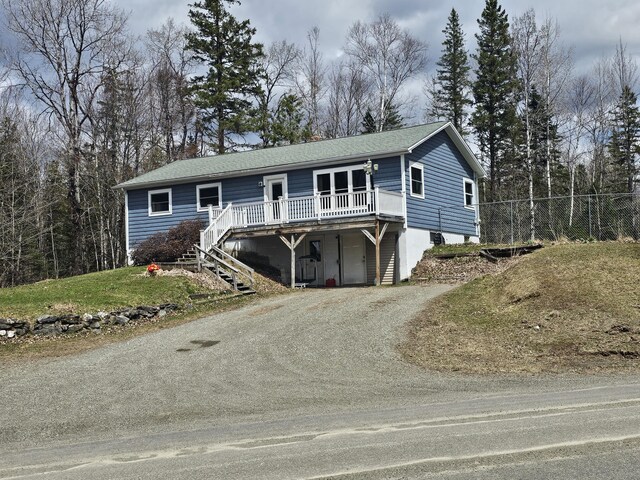 57 Owlsboro Rd, Mount Chase, ME 04765 - ranch-style home with a deck, driveway, a shingled roof, and stairs