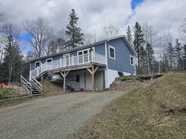 57 Owlsboro Rd, Mount Chase, ME 04765 - view of front of property featuring stairway, a wooden deck, and gravel driveway