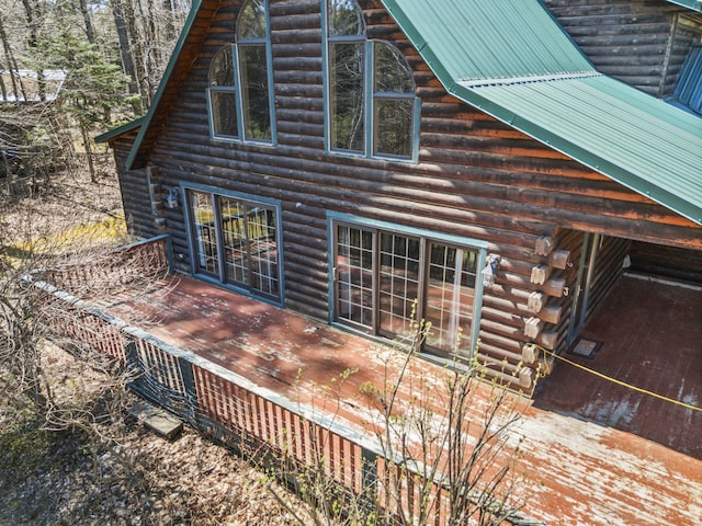 48 Thistle Ln, Sidney, ME 04330 - view of side of home with log exterior, a deck, and metal roof