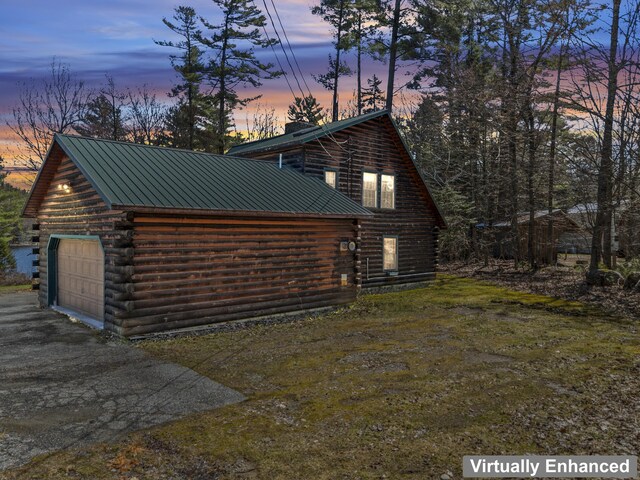 48 Thistle Ln, Sidney, ME 04330 - view of home's exterior with log siding, a detached garage, metal roof, and a chimney