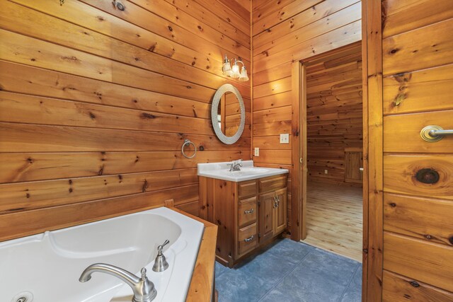 48 Thistle Ln, Sidney, ME 04330 - full bath featuring a jetted tub, tile patterned floors, vanity, and wooden walls