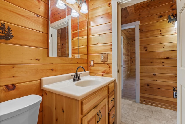 48 Thistle Ln, Sidney, ME 04330 - bathroom featuring wooden walls, toilet, and vanity
