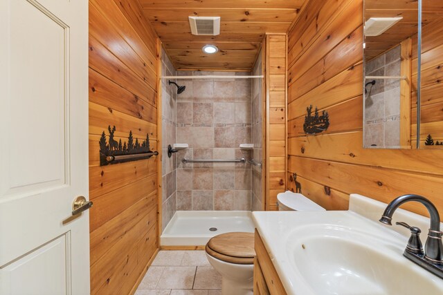 48 Thistle Ln, Sidney, ME 04330 - bathroom featuring toilet, a shower stall, wooden walls, tile patterned floors, and vanity