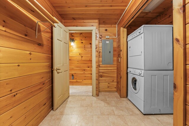 48 Thistle Ln, Sidney, ME 04330 - laundry room featuring stacked washer and clothes dryer, electric panel, wooden walls, and wooden ceiling