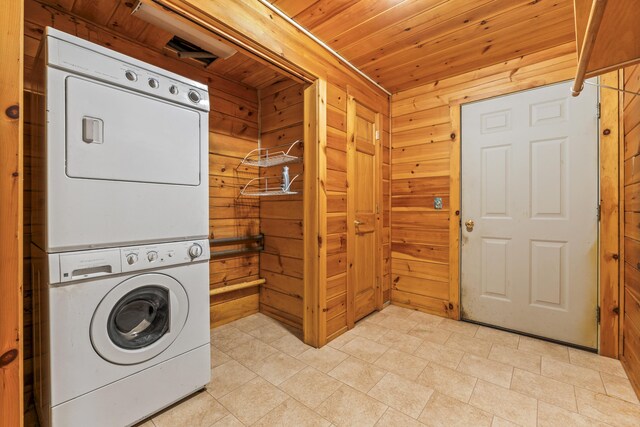 48 Thistle Ln, Sidney, ME 04330 - laundry room featuring stacked washer and clothes dryer, wooden walls, and wood ceiling