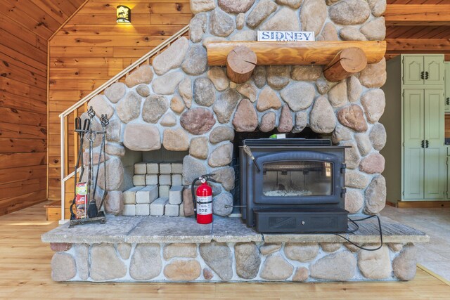 48 Thistle Ln, Sidney, ME 04330 - detailed view of a fire extinguisher, a wood stove, wood finished floors, wooden ceiling, and wooden walls