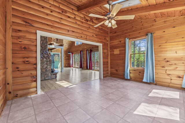 48 Thistle Ln, Sidney, ME 04330 - empty room with wood ceiling with exposed beams, a ceiling fan, light tile patterned floors, and wood walls