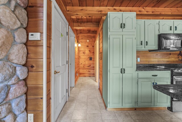 48 Thistle Ln, Sidney, ME 04330 - kitchen with green cabinetry, black microwave, wood ceiling, stainless steel range with electric stovetop, and wood walls