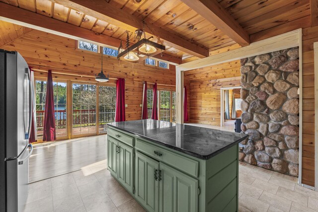 48 Thistle Ln, Sidney, ME 04330 - kitchen featuring green cabinets, freestanding refrigerator, dark countertops, wood ceiling, and wood walls