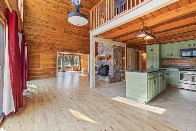 48 Thistle Ln, Sidney, ME 04330 - kitchen featuring green cabinets, stainless steel range with electric cooktop, black microwave, wood walls, and a towering ceiling