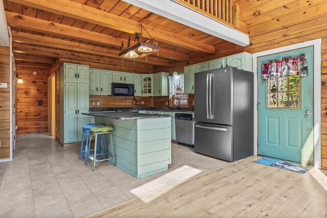 48 Thistle Ln, Sidney, ME 04330 - kitchen with appliances with stainless steel finishes, wood walls, green cabinets, dark countertops, and wood ceiling with exposed beams