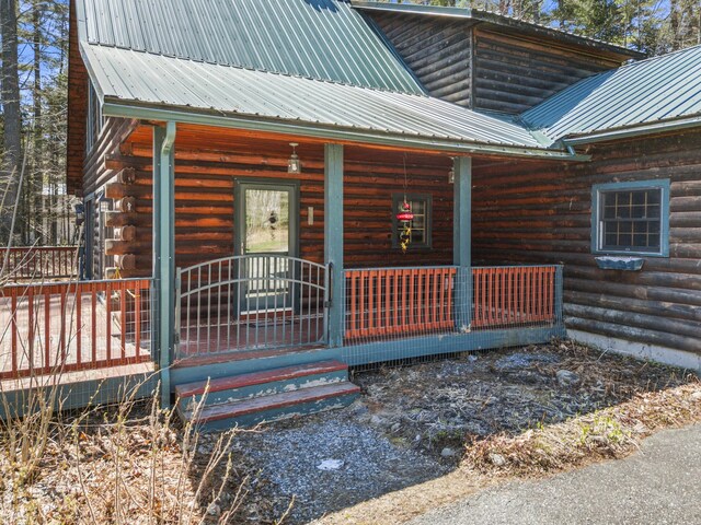 48 Thistle Ln, Sidney, ME 04330 - property entrance featuring a porch, metal roof, and log exterior