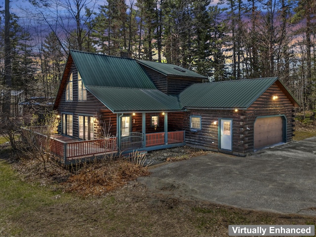 48 Thistle Ln, Sidney, ME 04330 - log cabin with driveway, log exterior, metal roof, a porch, and an attached garage
