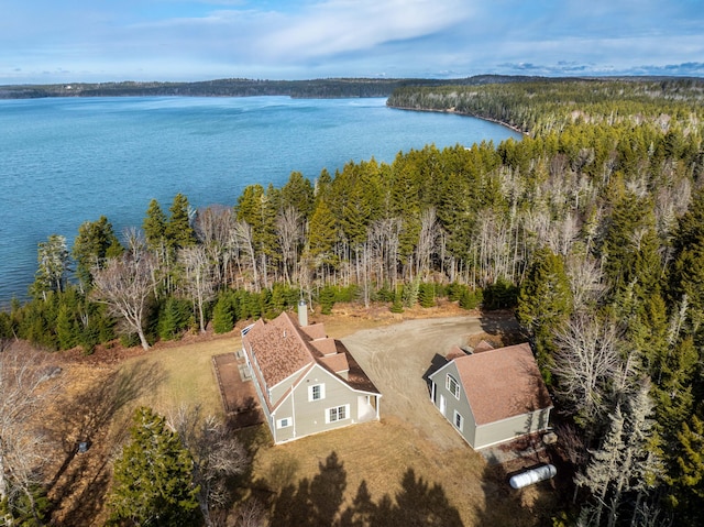 aerial view with a water view and a forest view