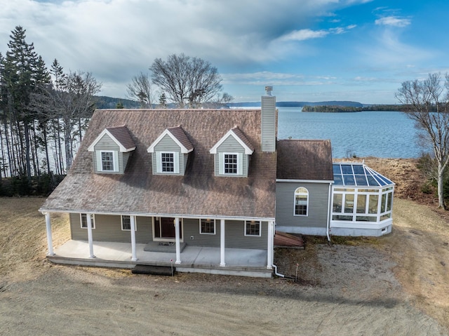 view of front of home with a water view and a chimney