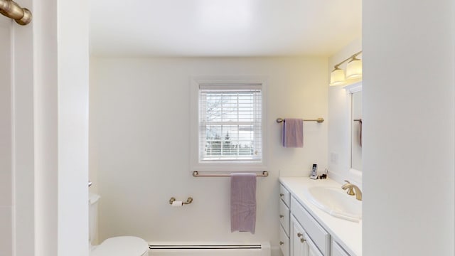 half bath featuring toilet, baseboard heating, and vanity