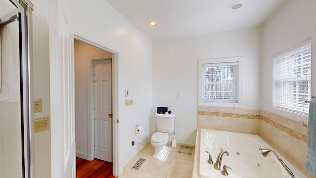 bathroom with visible vents, toilet, recessed lighting, and a jetted tub