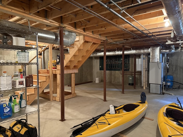 unfinished below grade area featuring heating unit and stairway
