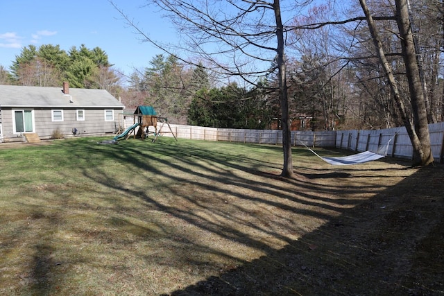 view of yard with a playground and a fenced backyard