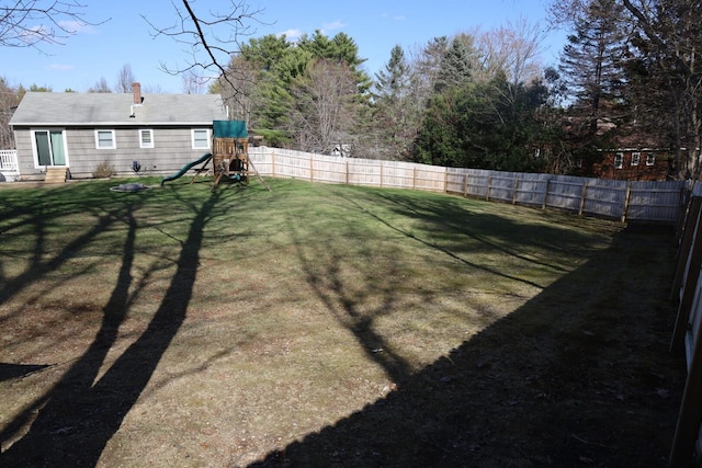 view of yard featuring a fenced backyard and a playground