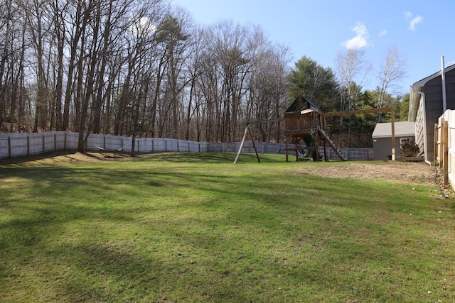view of yard with a playground and a fenced backyard