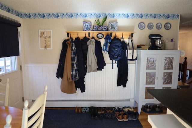 mudroom featuring wood finished floors and a wainscoted wall