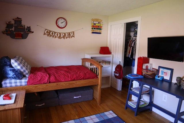 bedroom with a closet and wood finished floors