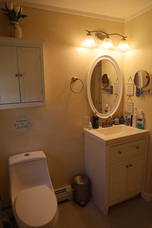 bathroom with vanity, baseboards, baseboard heating, and toilet
