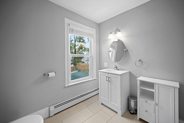 bathroom with toilet, baseboard heating, and vanity