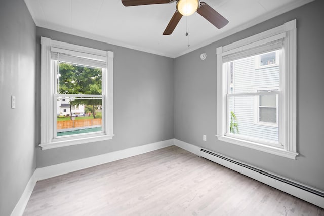unfurnished room with a baseboard radiator, wood finished floors, a ceiling fan, and baseboards