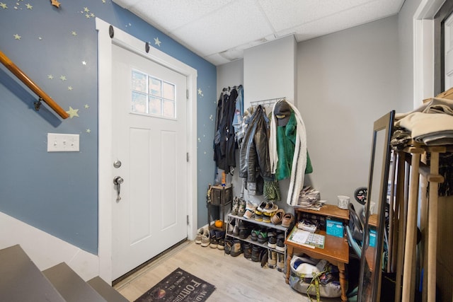 entryway featuring wood finished floors and a drop ceiling