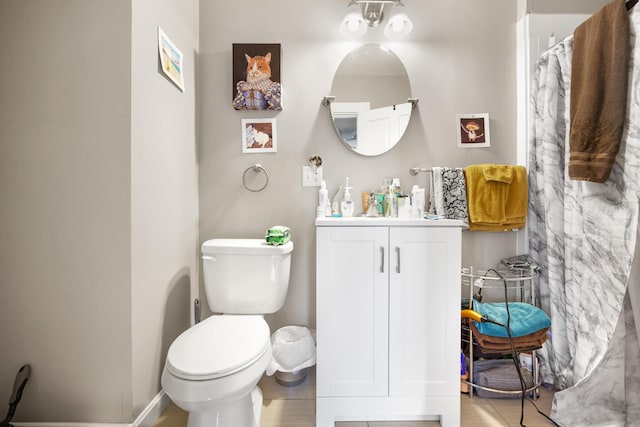 full bathroom featuring vanity, toilet, and baseboards